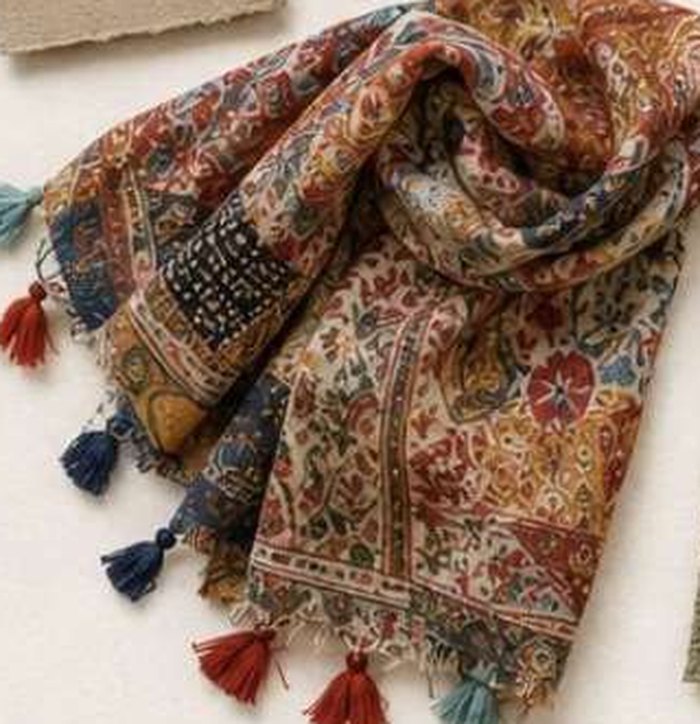 A paisley scarf with hand-tied tassels along both ends